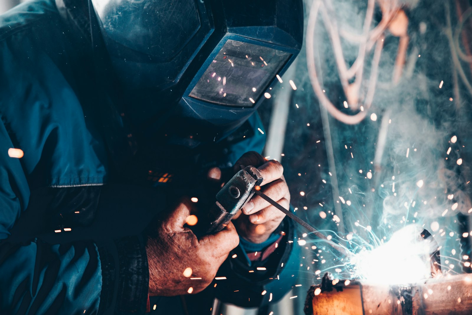 Welder fabricating a metal industrial component